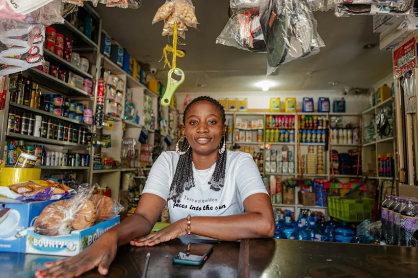 African e-commerce business owner managing orders from a retail counter