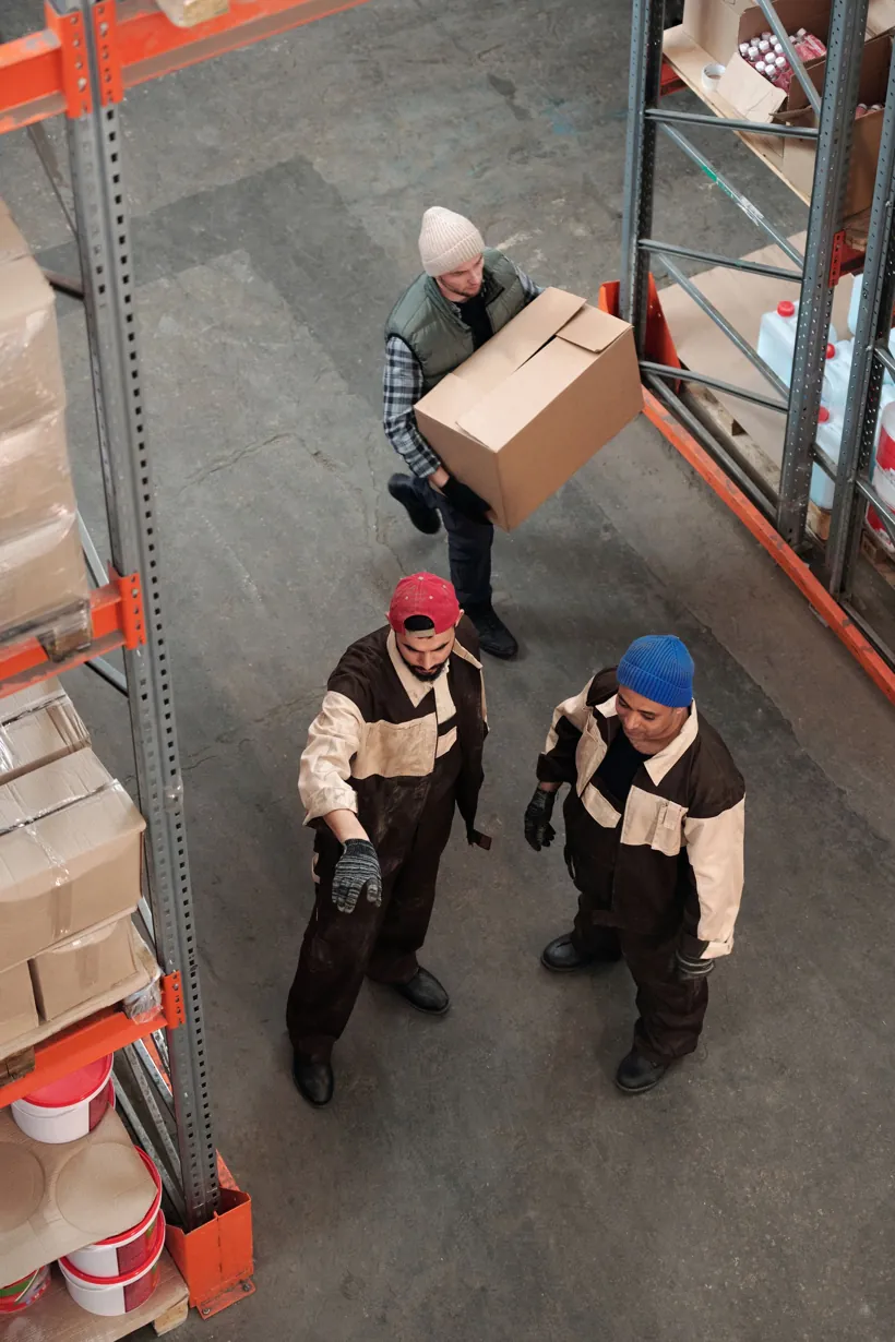 Logistics and procurement team reviewing inventory in a warehouse